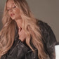 A blonde model advertising hair extensions in a studio
